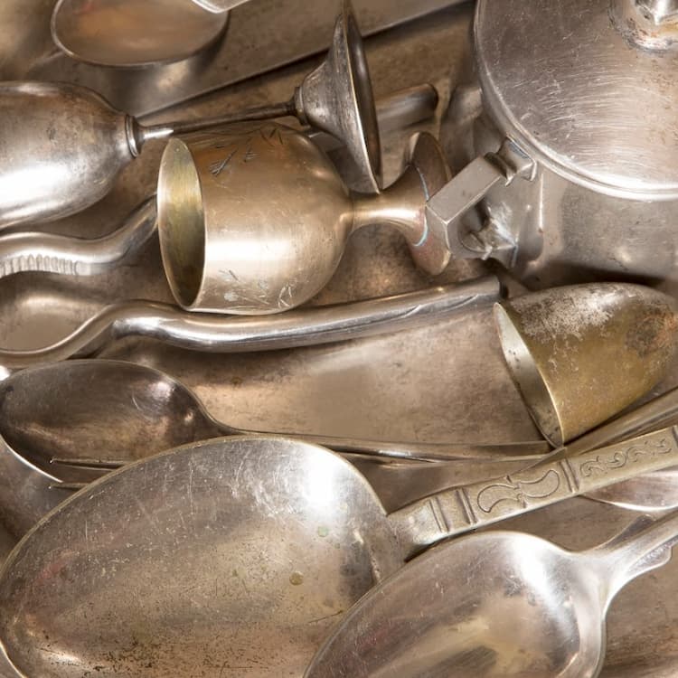 A silver tray full of various sterling silver flatware