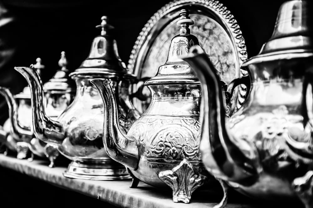 A silver tray with various silverware